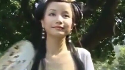 Beautiful Chinese Girl Walks Through A Garden