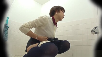 This glorious Asian babe was spied on by an voyeur while taking a piss in public toilet