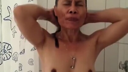 Asian woman with dark nipples and aureola showering