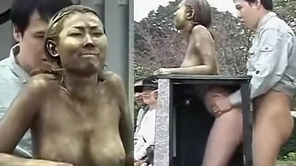 Golden Japanese statue penetrated from the behind